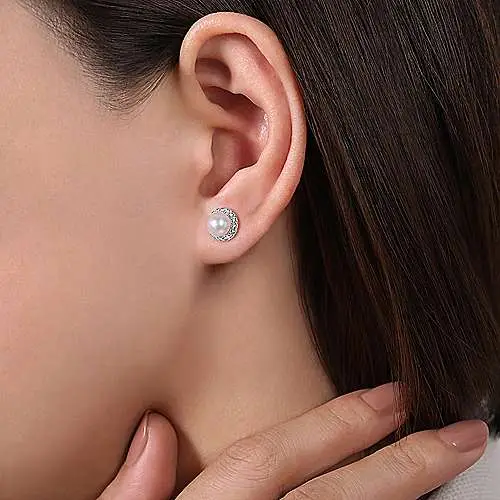 Close-up of a person's ear showing a diamond stud earring