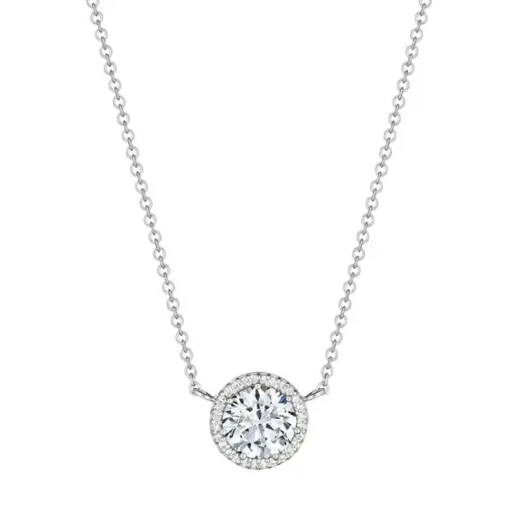 A silver necklace with a round pendant set with diamonds or a similar gemstone, hanging against a plain white background.
