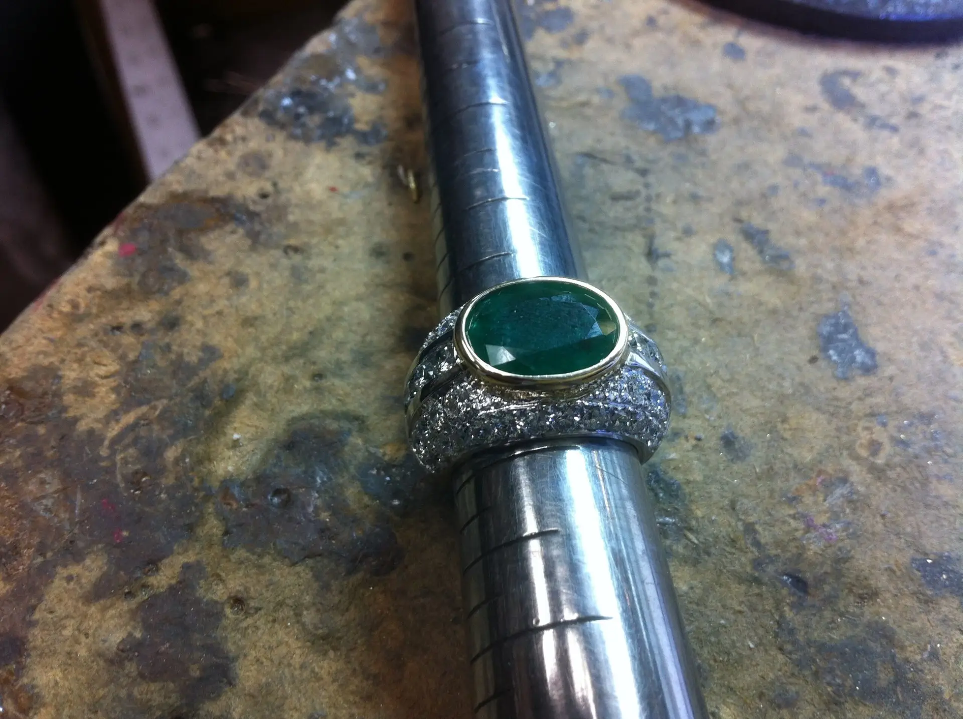 A platinum diamond engagement ring with a prominent, central diamond and channel-set diamonds along the band.